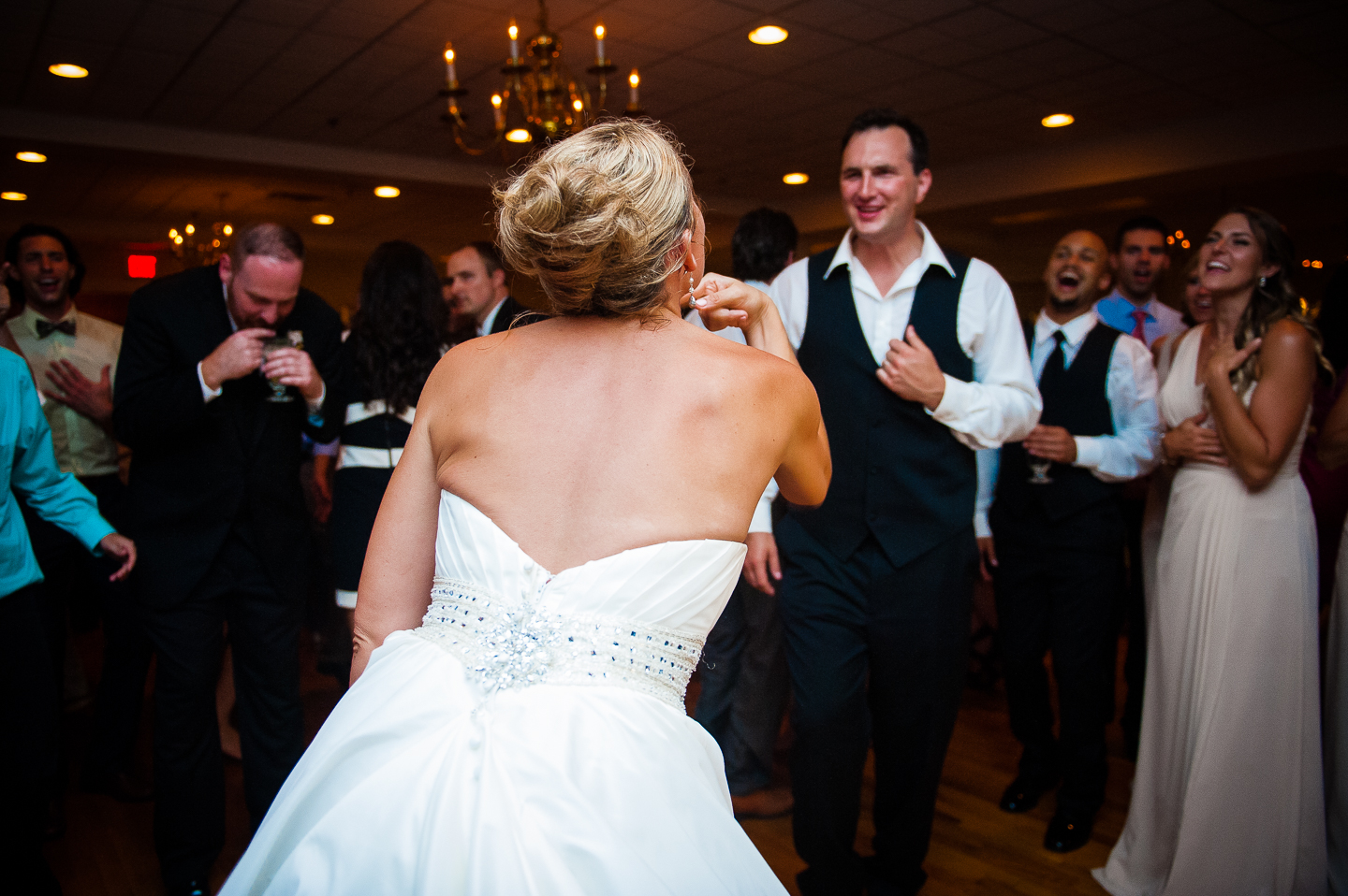 a bride and groom at the center of the dance floor 