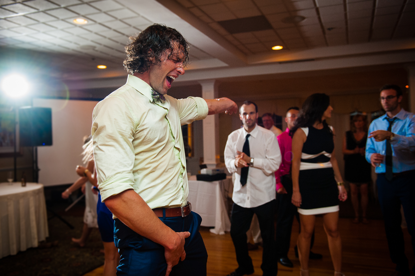 a wedding guest dancing during this evening wedding reception 