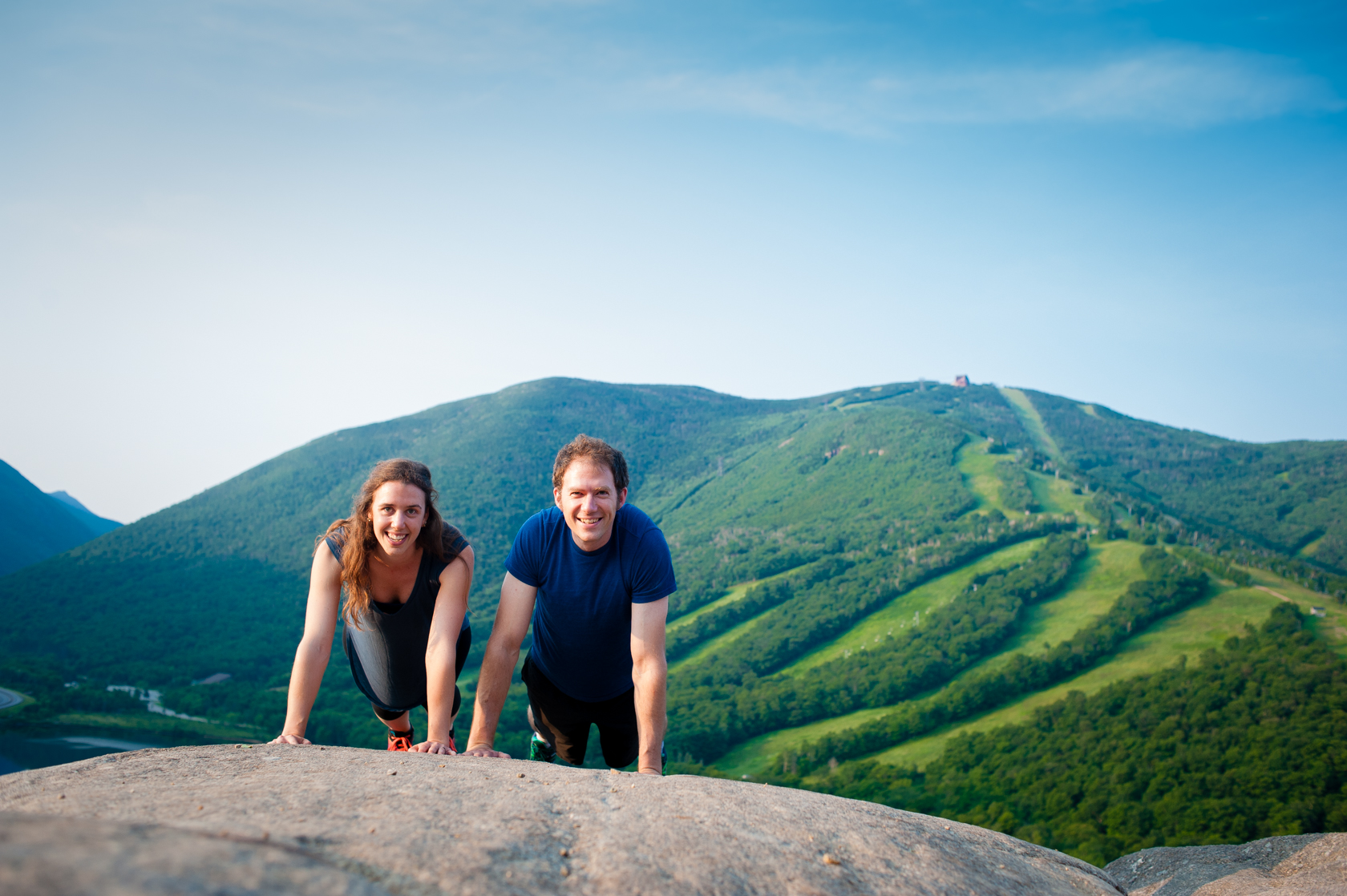 adorable couple battling in a mountaintop push up contest