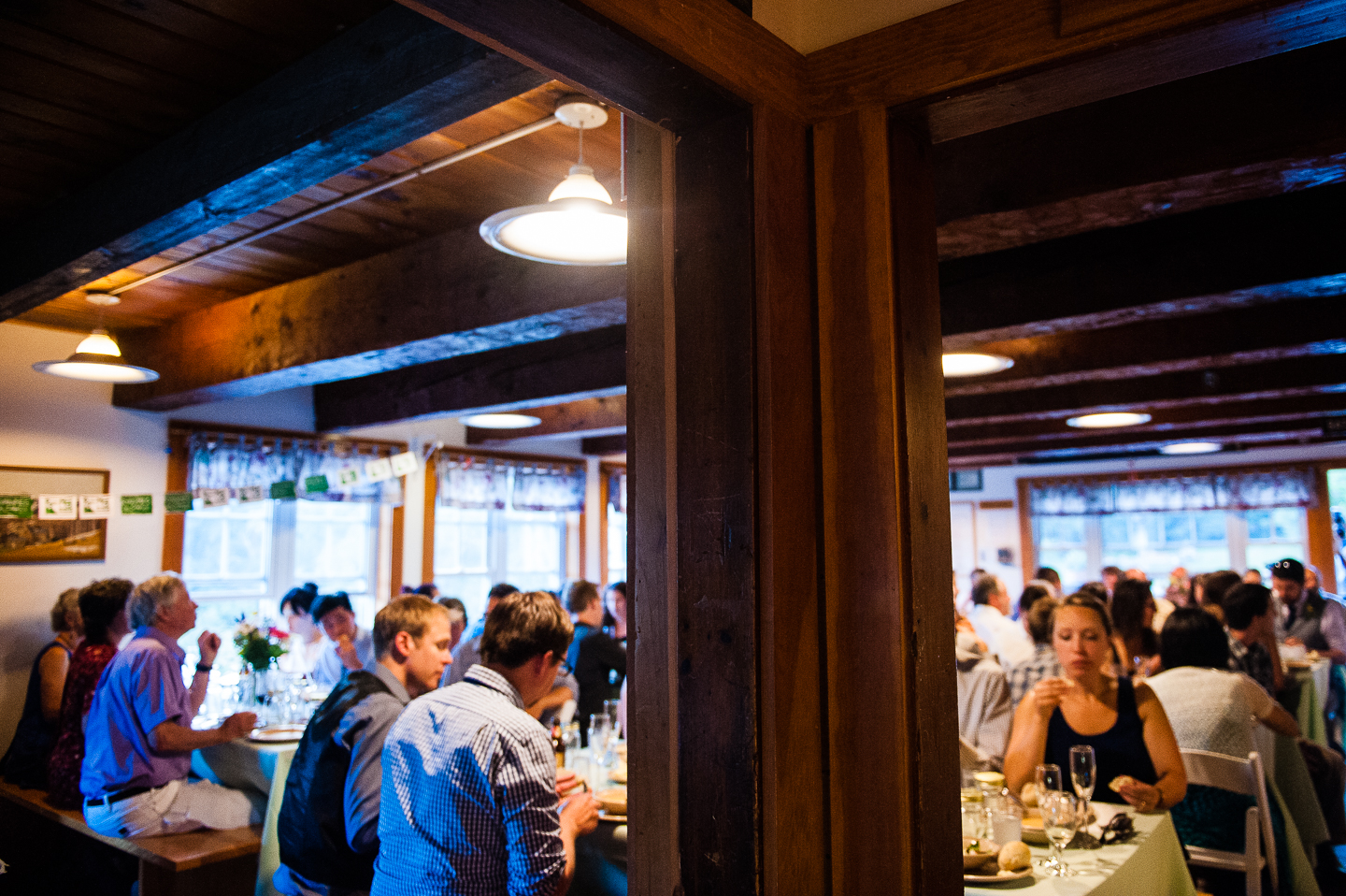 guests sat at long wooden tables during the family style dinner reception