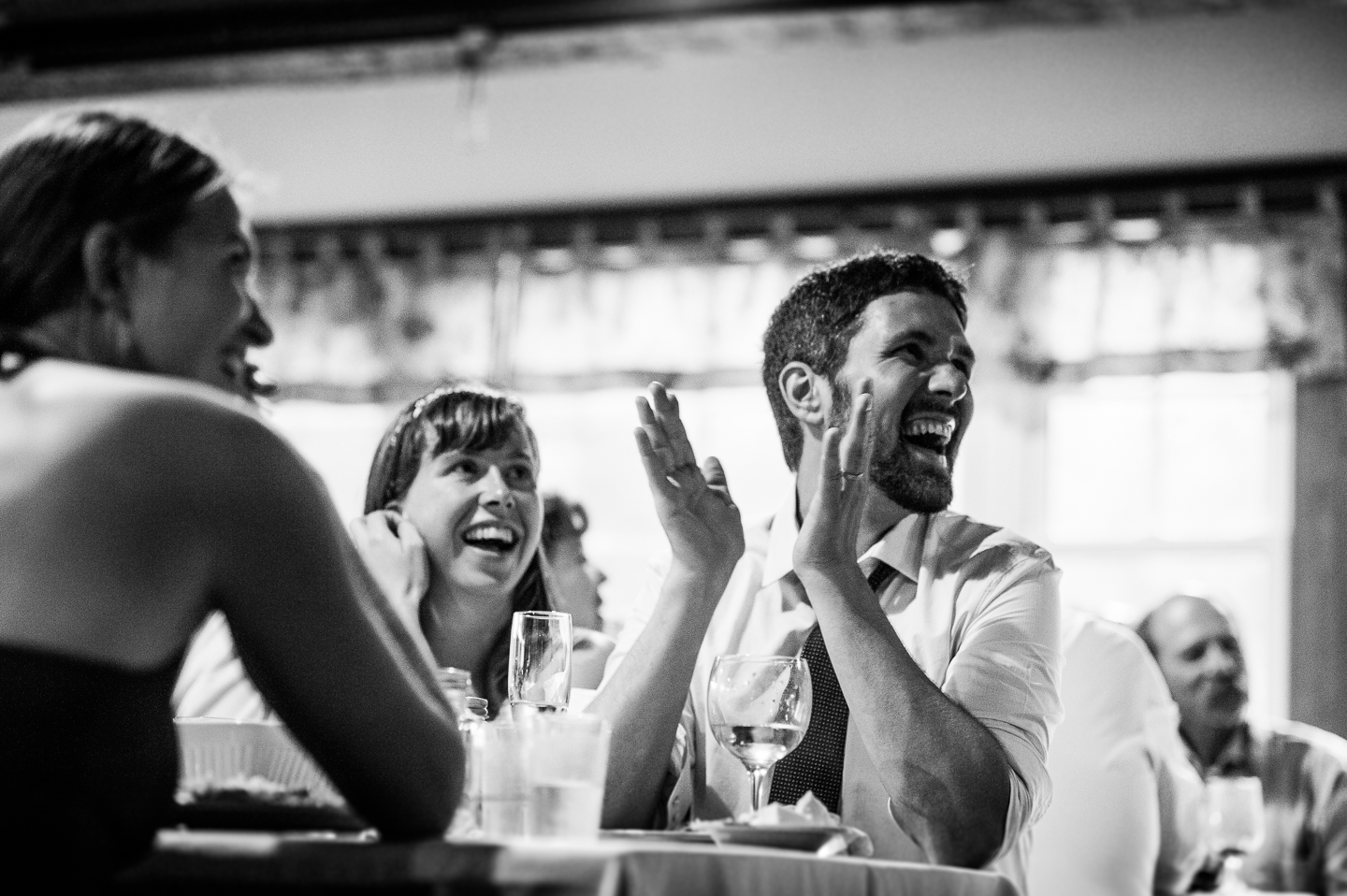 bride and groom clapping for an impromptu speeches during their mountain wedding reception