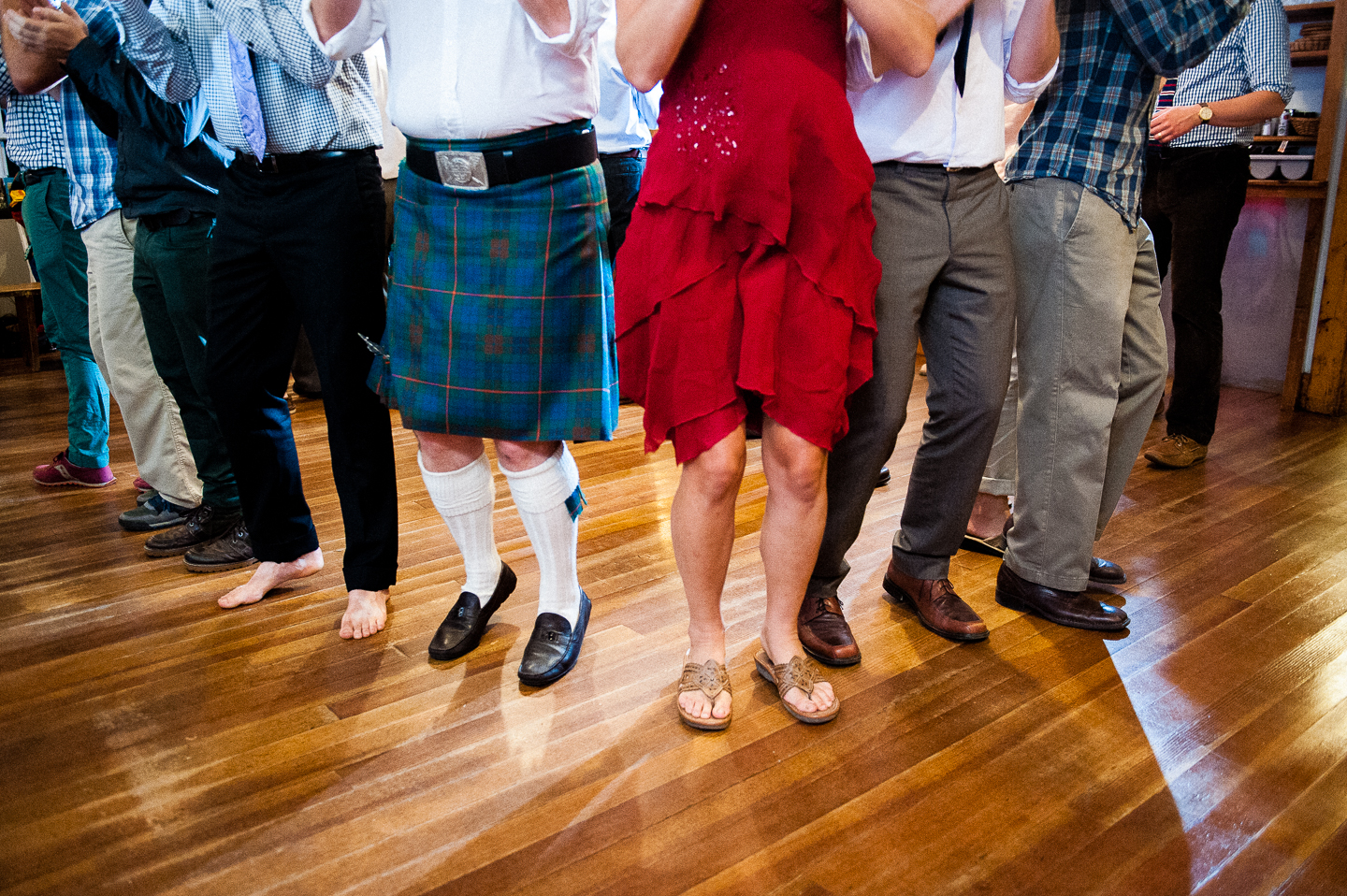 a wedding guest wearing a kilt shows off his moves on the dance floor 