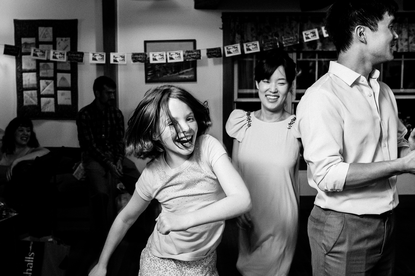 young wedding guest enjoys some contra dancing at a rustic wedding reception