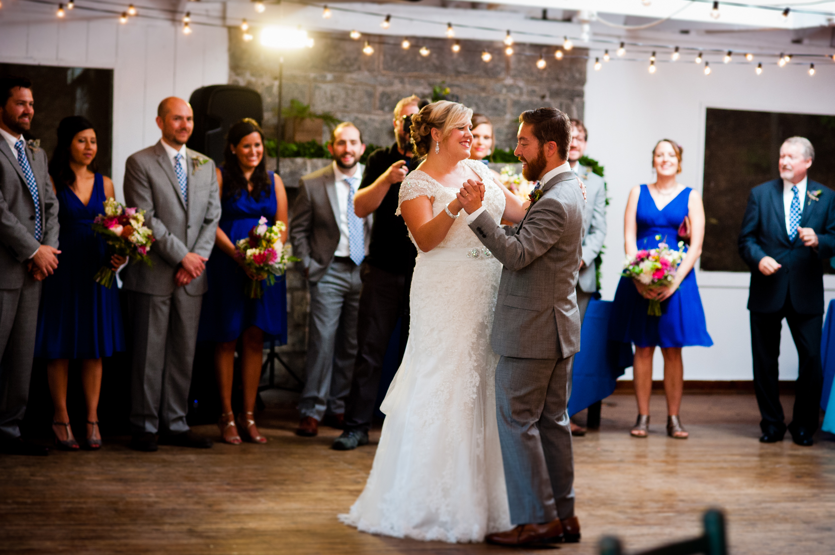 bride and groom enjoy a fun first dance during their summer camp wedding 