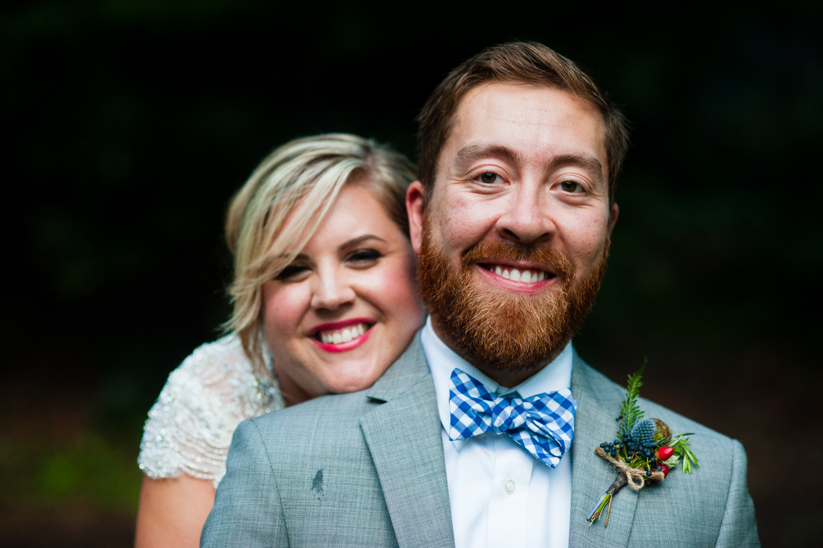 bride and groom smiling at the camera during their summer camp wedding portraits