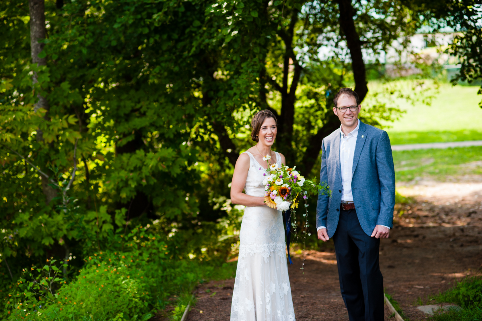 Bride and Groom laughing together before they head to their summer camp wedding ceremony