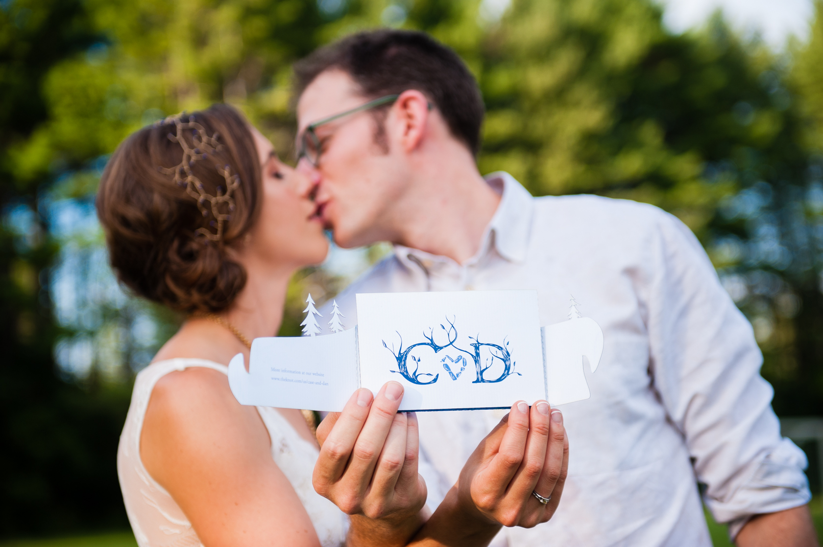 beautiful bride and groom show off their beautiful handmade stationary