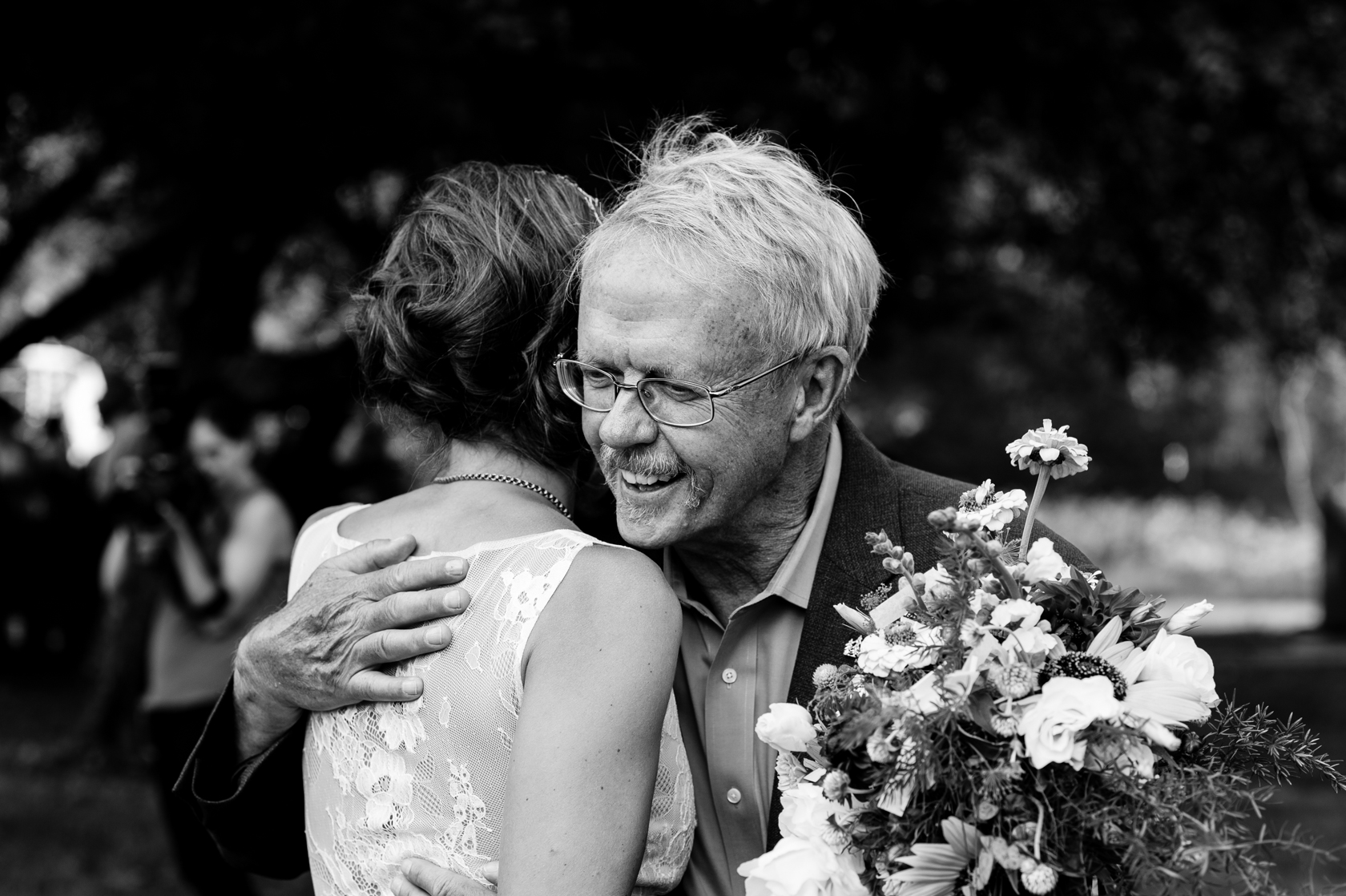 bride and her dad give each other a quick hug before he walks her down the aisle