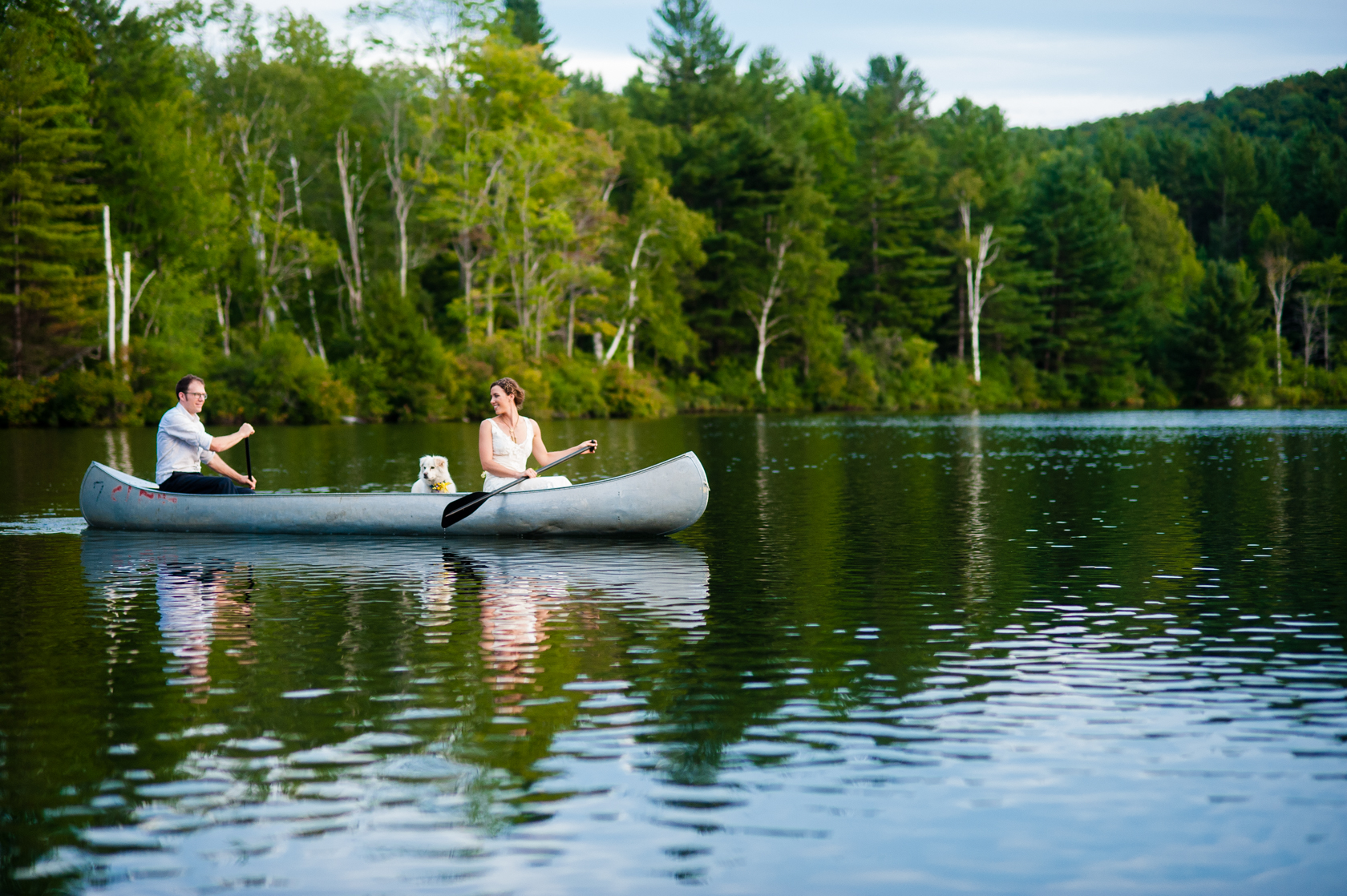 bride and groom adventure out on the lake in a canoe