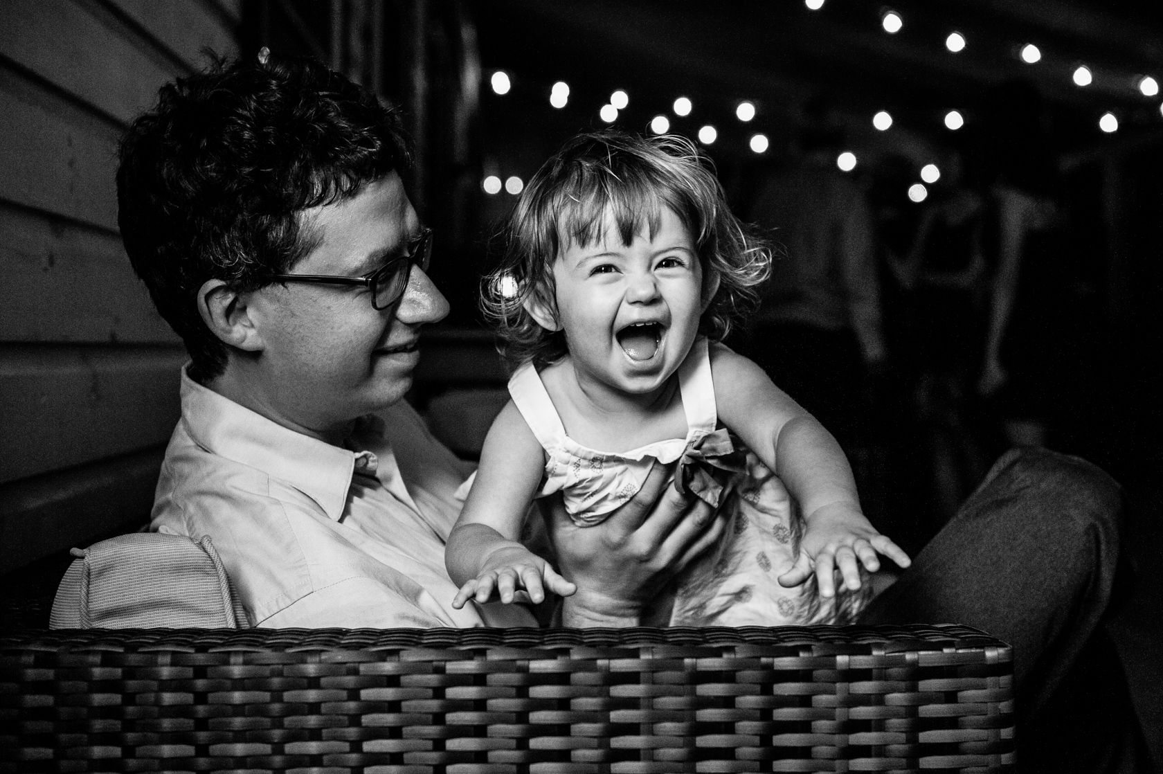 little girl laughing as she flies through the air 