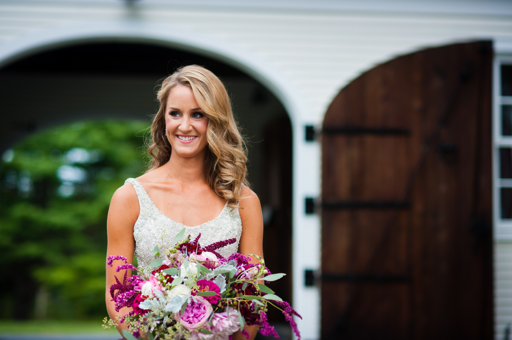 gorgeous bride holds her large floral bouquet 