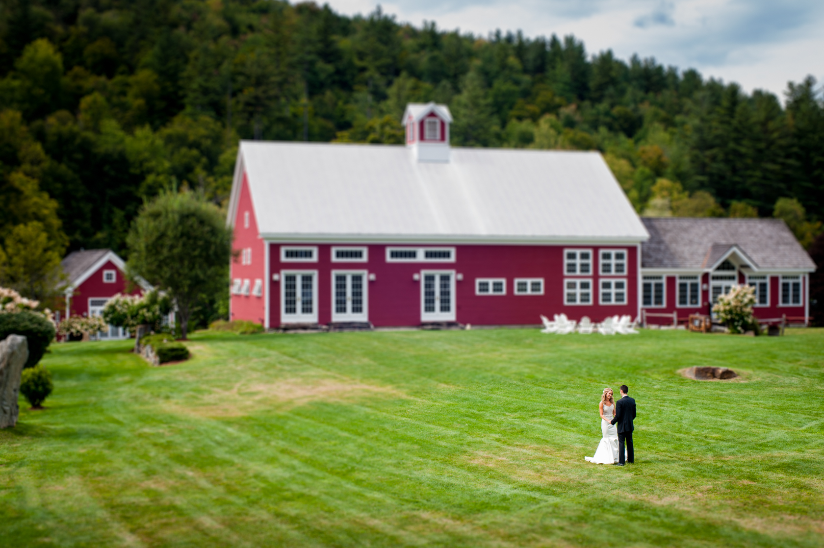 beautiful bride and groom first look in front of a gorgeous red barn 