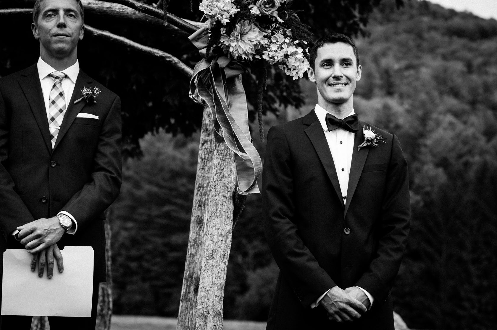 groom waits for his bride at the end of the ceremony aisle 