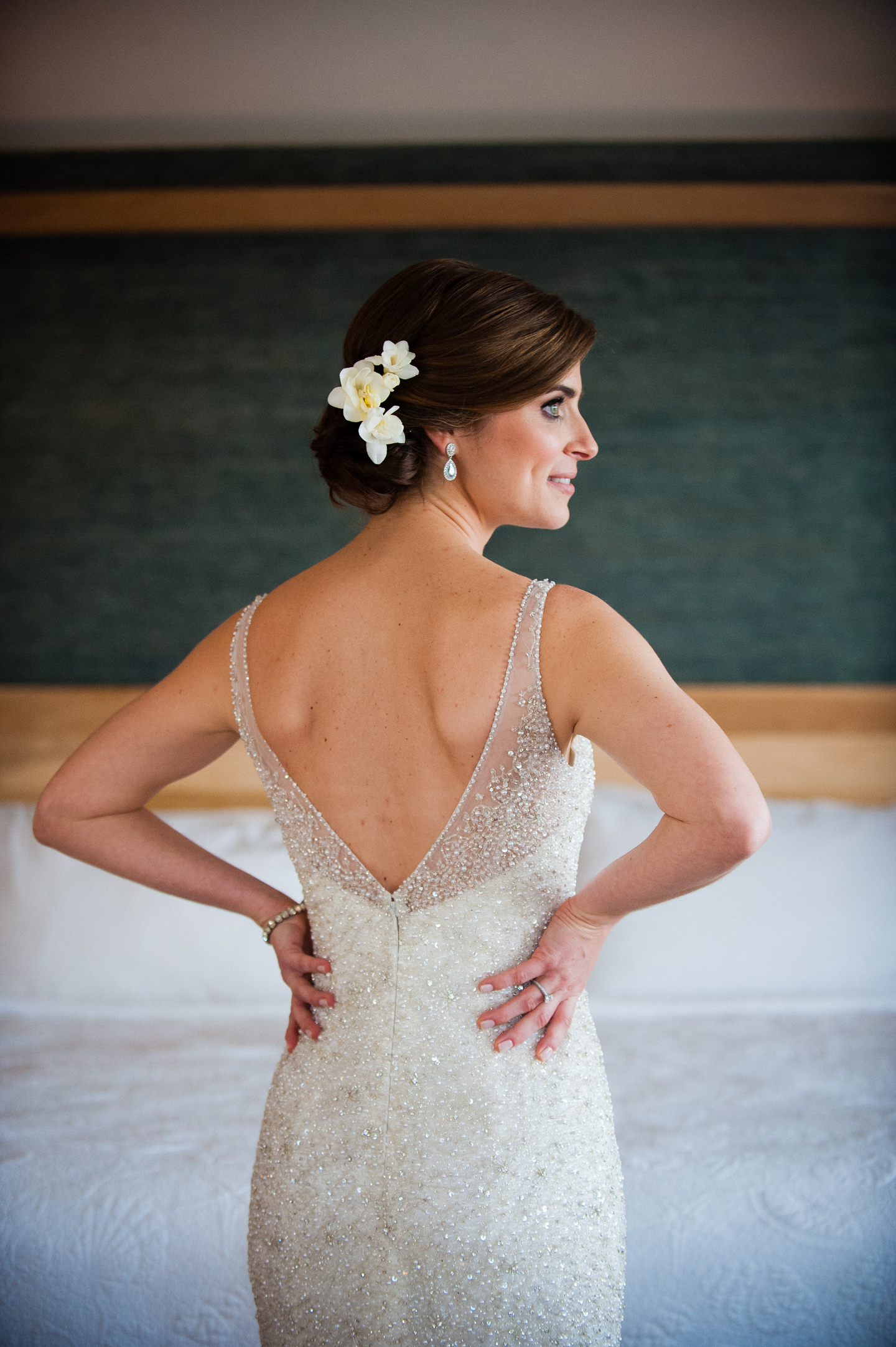 beautiful bride shows off her low cut back beaded wedding gown 