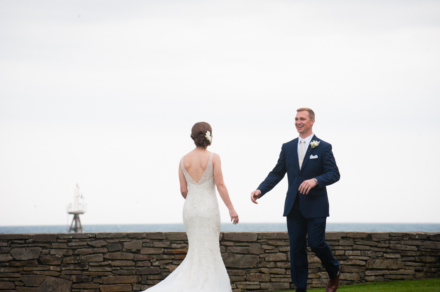 bride and groom very excited to see each other during their oceanside first look  