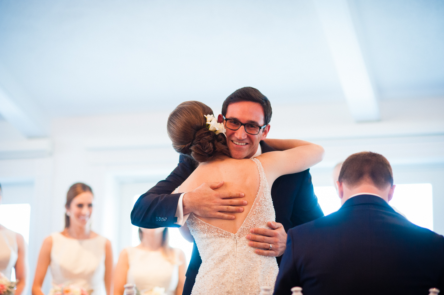 bride and a ceremony reader give each other a hug 