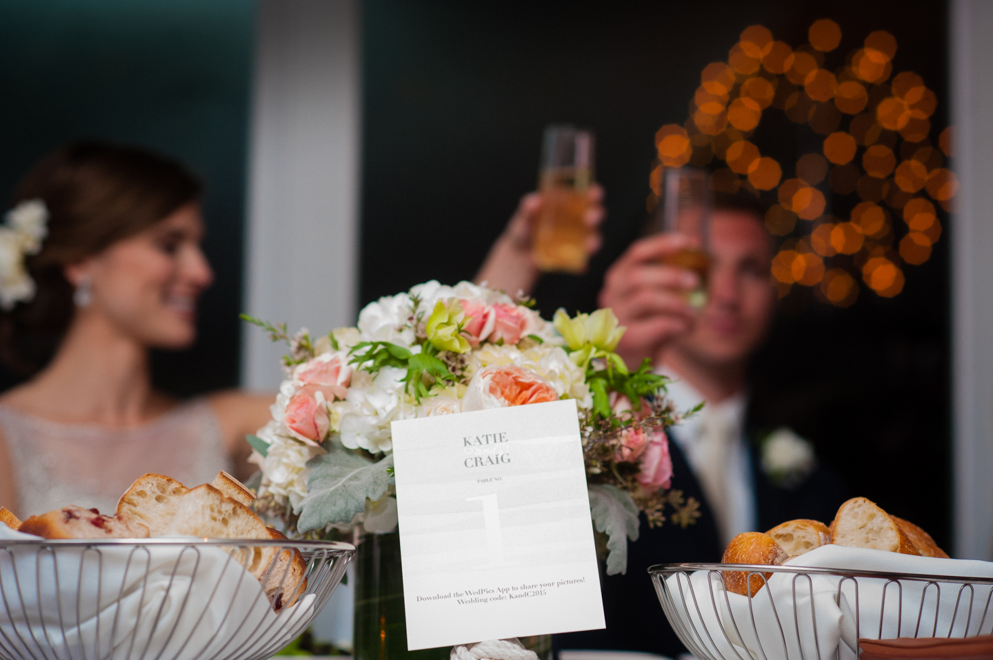 bride and groom toast in the background of this photo