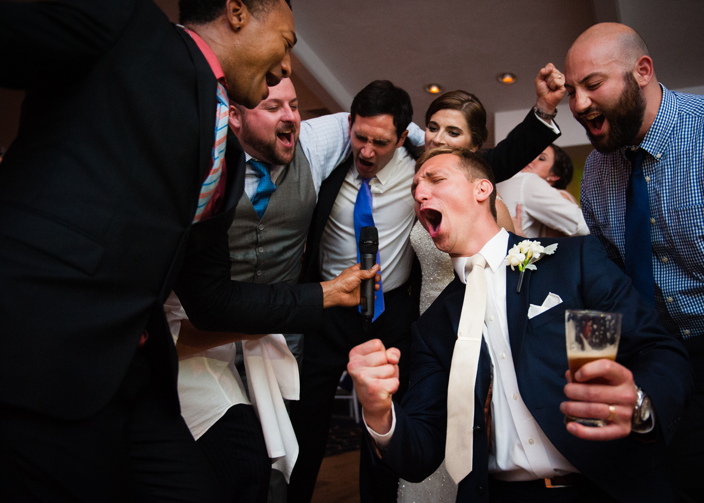 groom sings on the dance floor with the band  