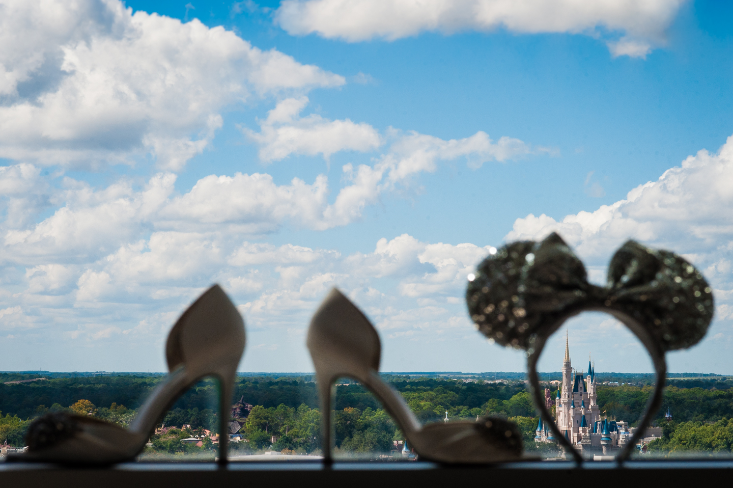 disneys magical kingdom framed by brides shoes in a window 