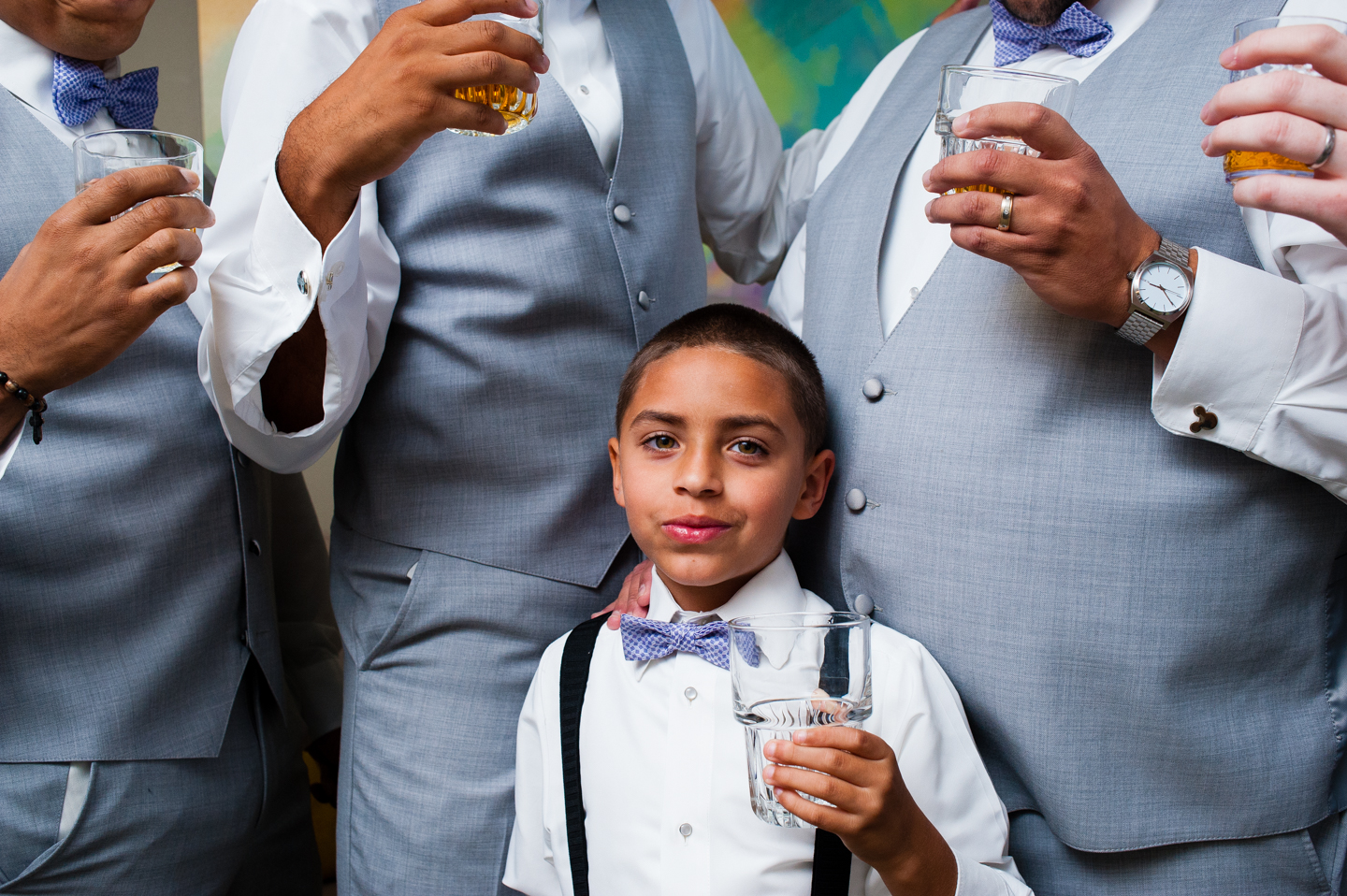 adorable ring bearer celebrating with groomsmen