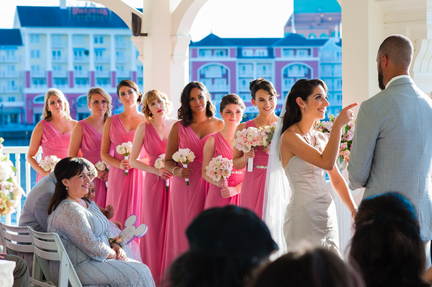 bride goofily points at groom during disney wedding ceremony 