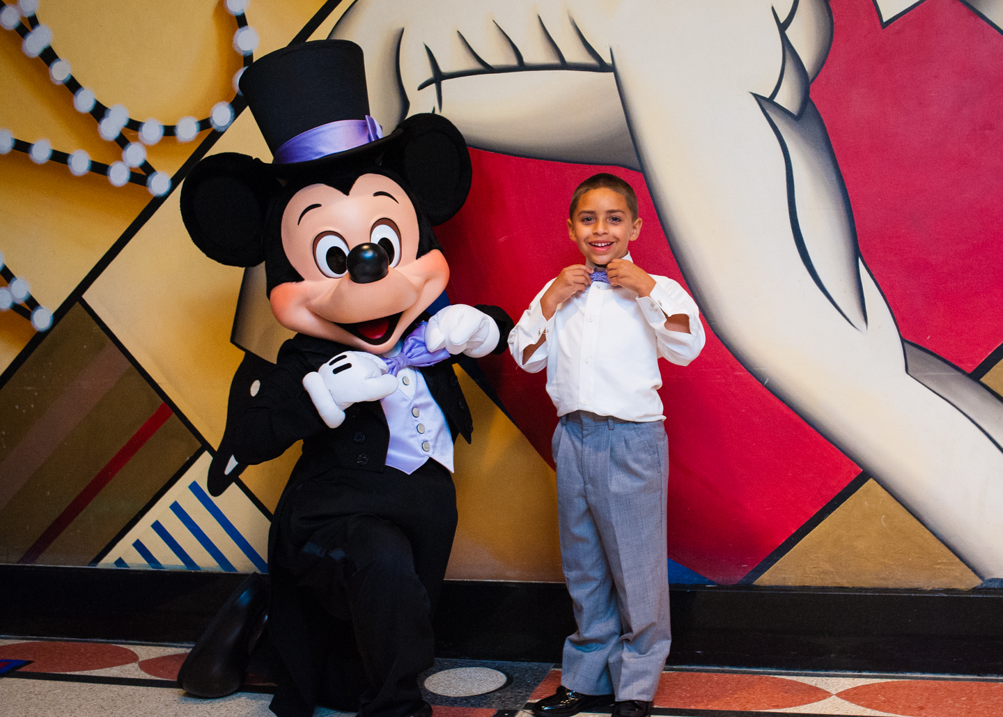 mickey mouse and ring bearer fixing bowties together 