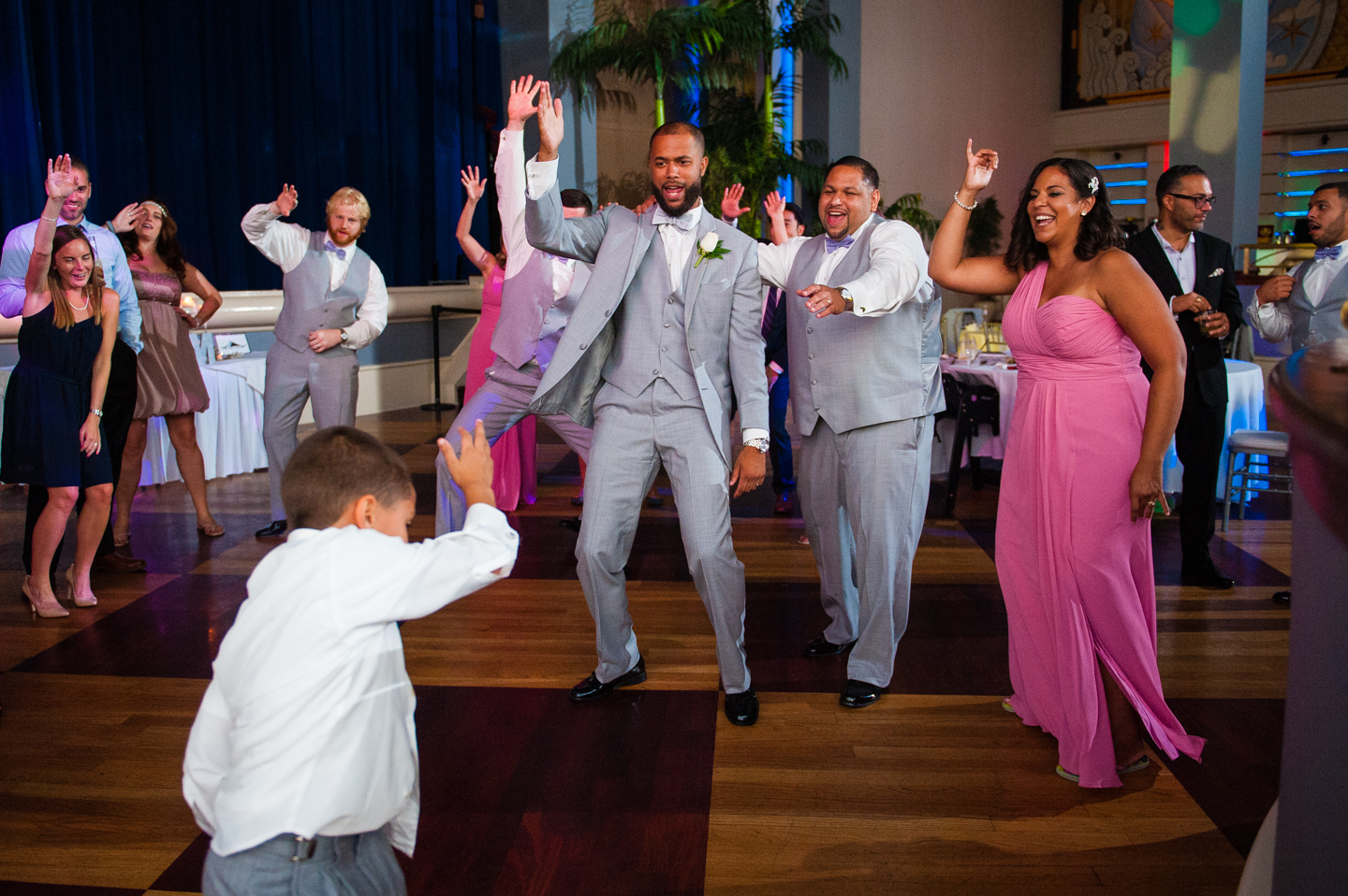 groom and ring bearer dancing during disney world wedding reception 