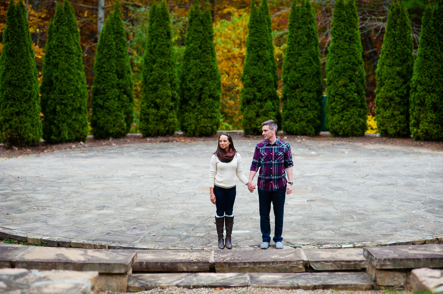 couple holds hands during asheville arboretum engagement session 