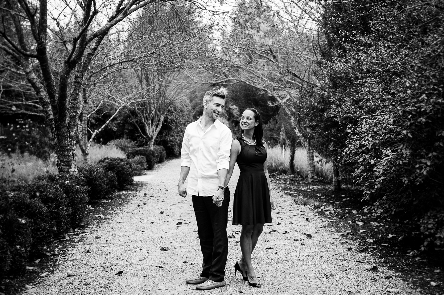 NC Arboretum pathway with engaged couple holding hands