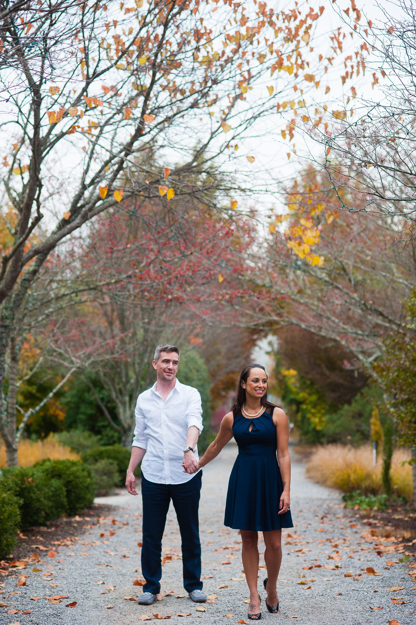 couple holding hands fall NC Arboretum engagement session 