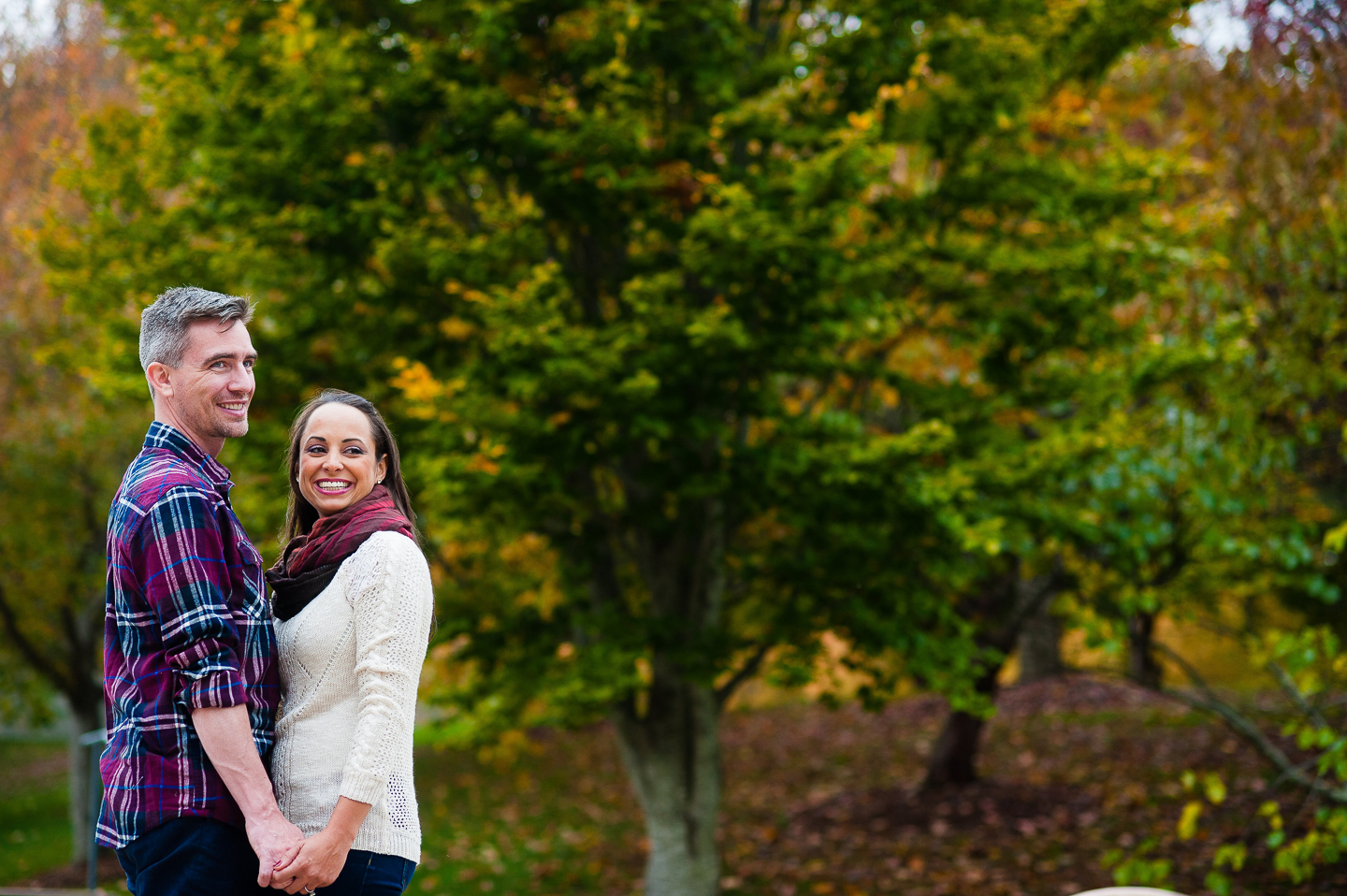stylish couple laughing during fall engagement photos in asheville nc 