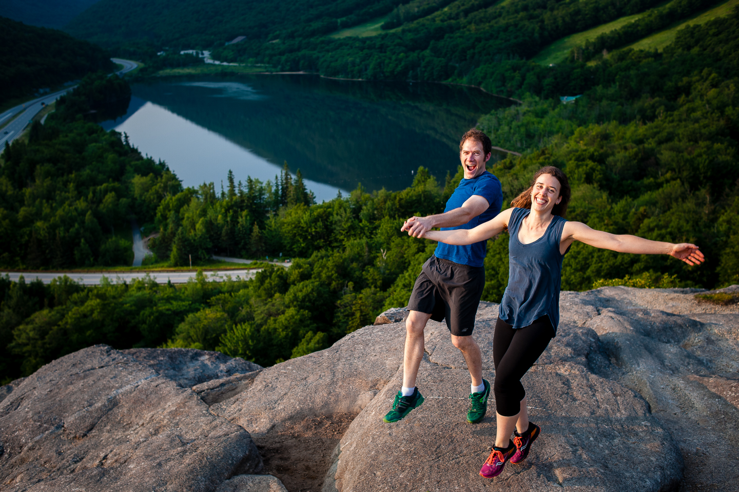 young engaged couple goofing off during mountaintop engagement session