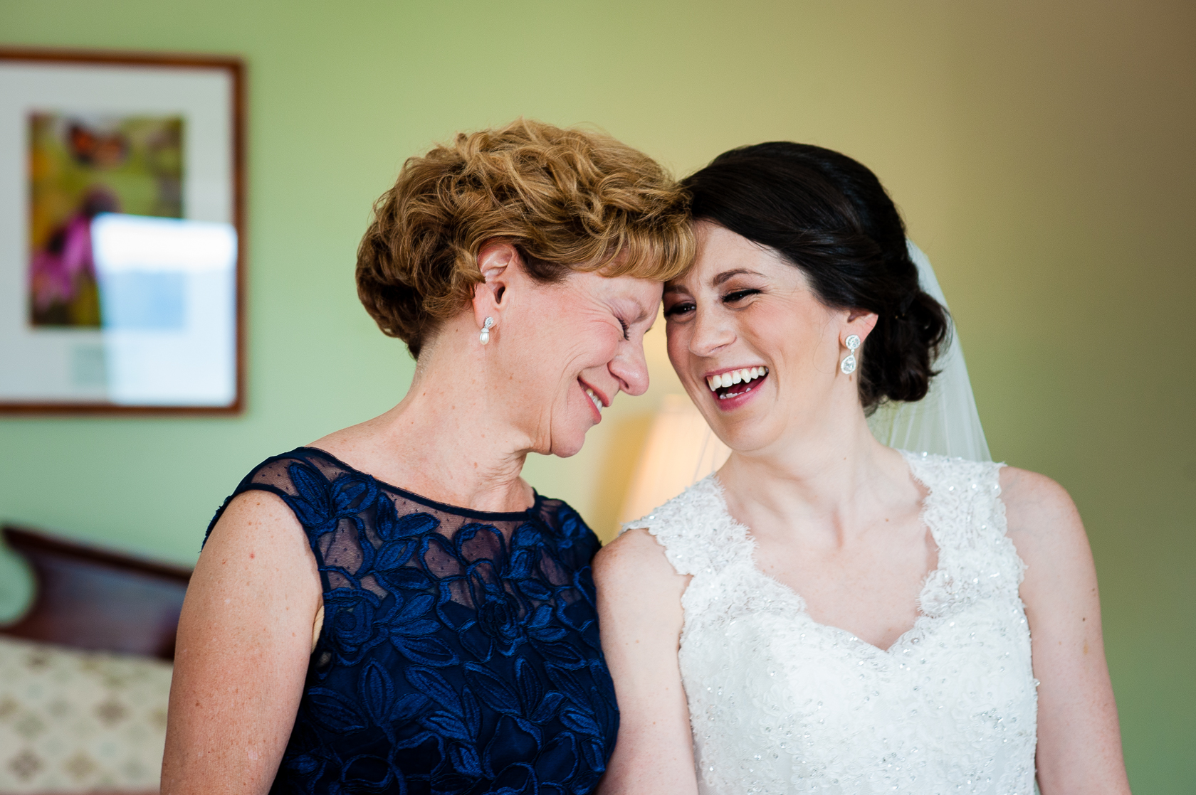 gorgeous bride and her mom laughing together