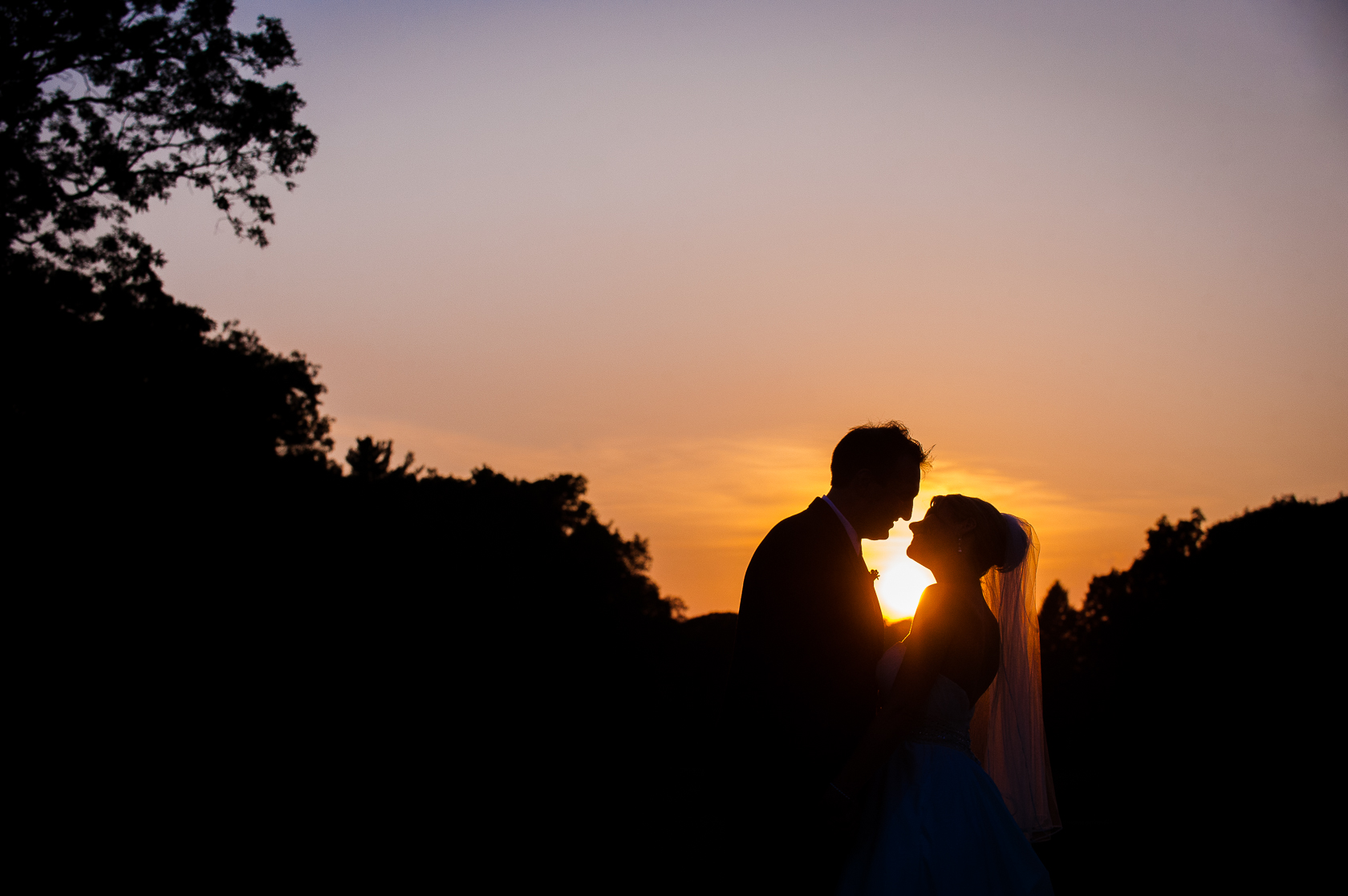 bride and groom silhouette at sunset 