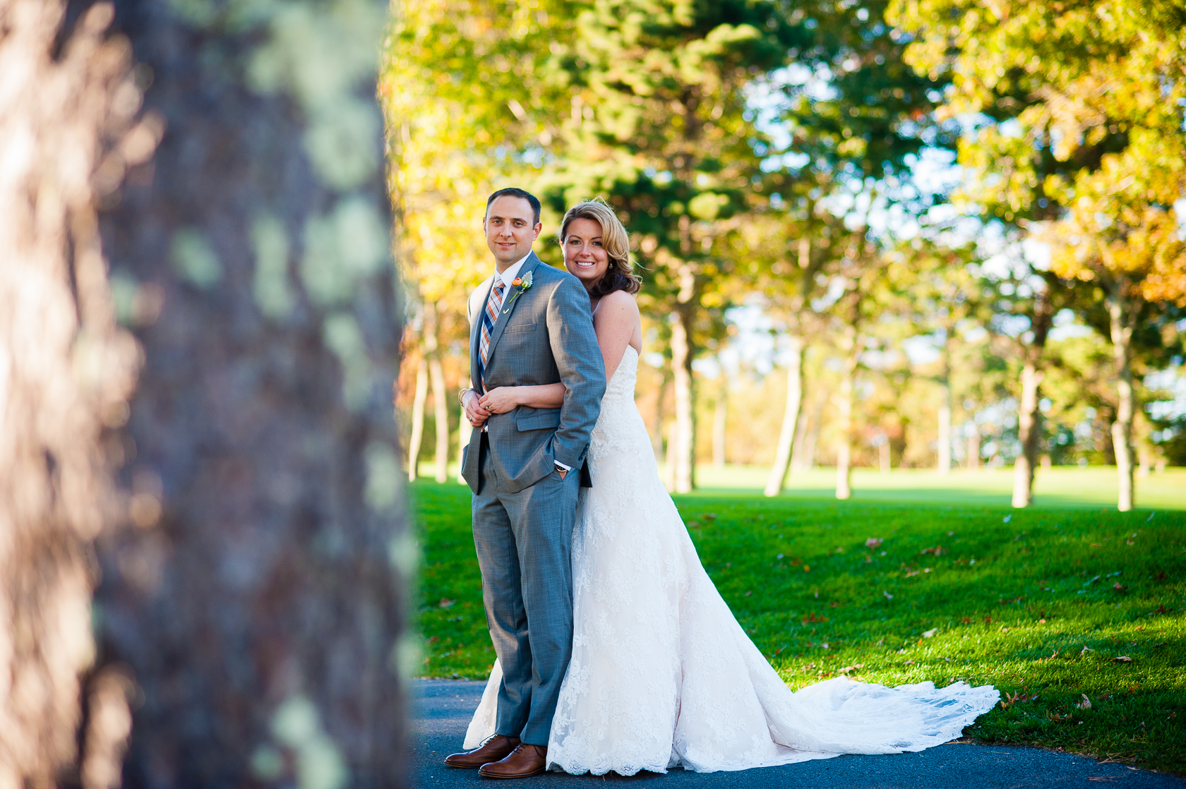 bride and groom embracing during fall wedding 