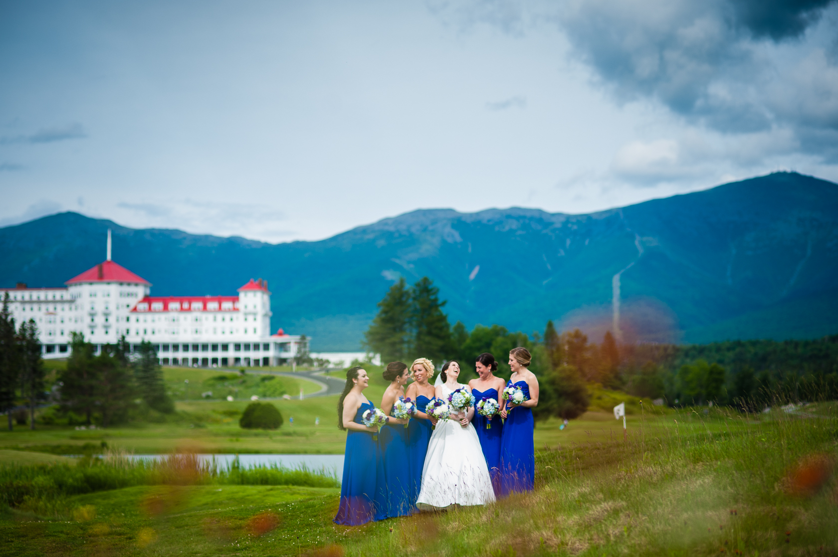 bride and her pretty ladies in field with mountains in background 