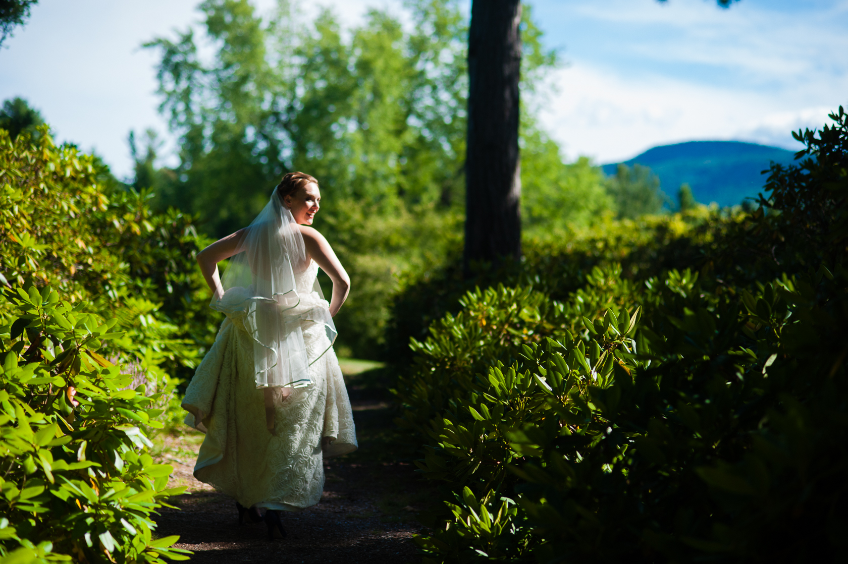 bride walking down wooded path bridal portrait 