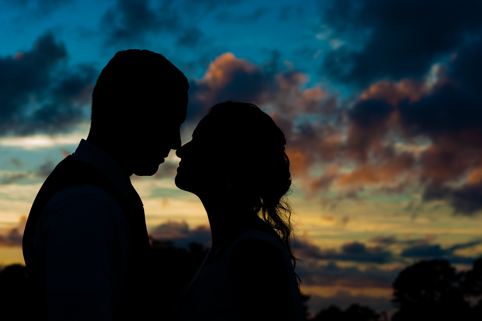 silhouette of bride and groom with gorgeous sunset 