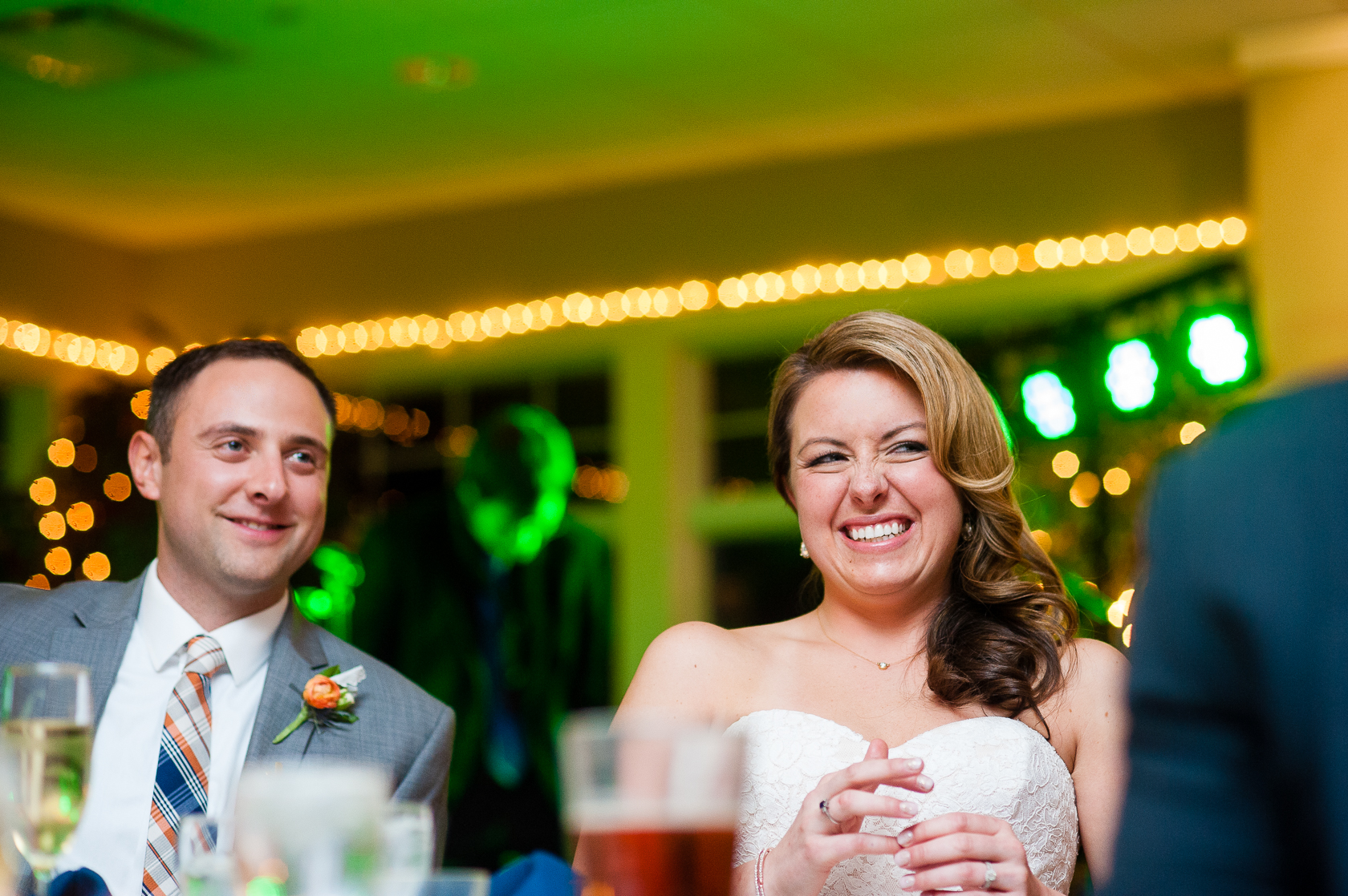 bride and groom laughing during toasts