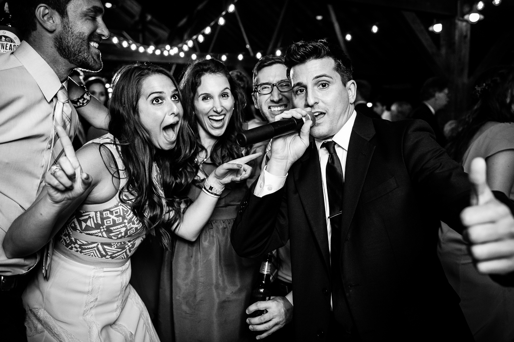 wedding guests goof off on dance floor of barn wedding reception