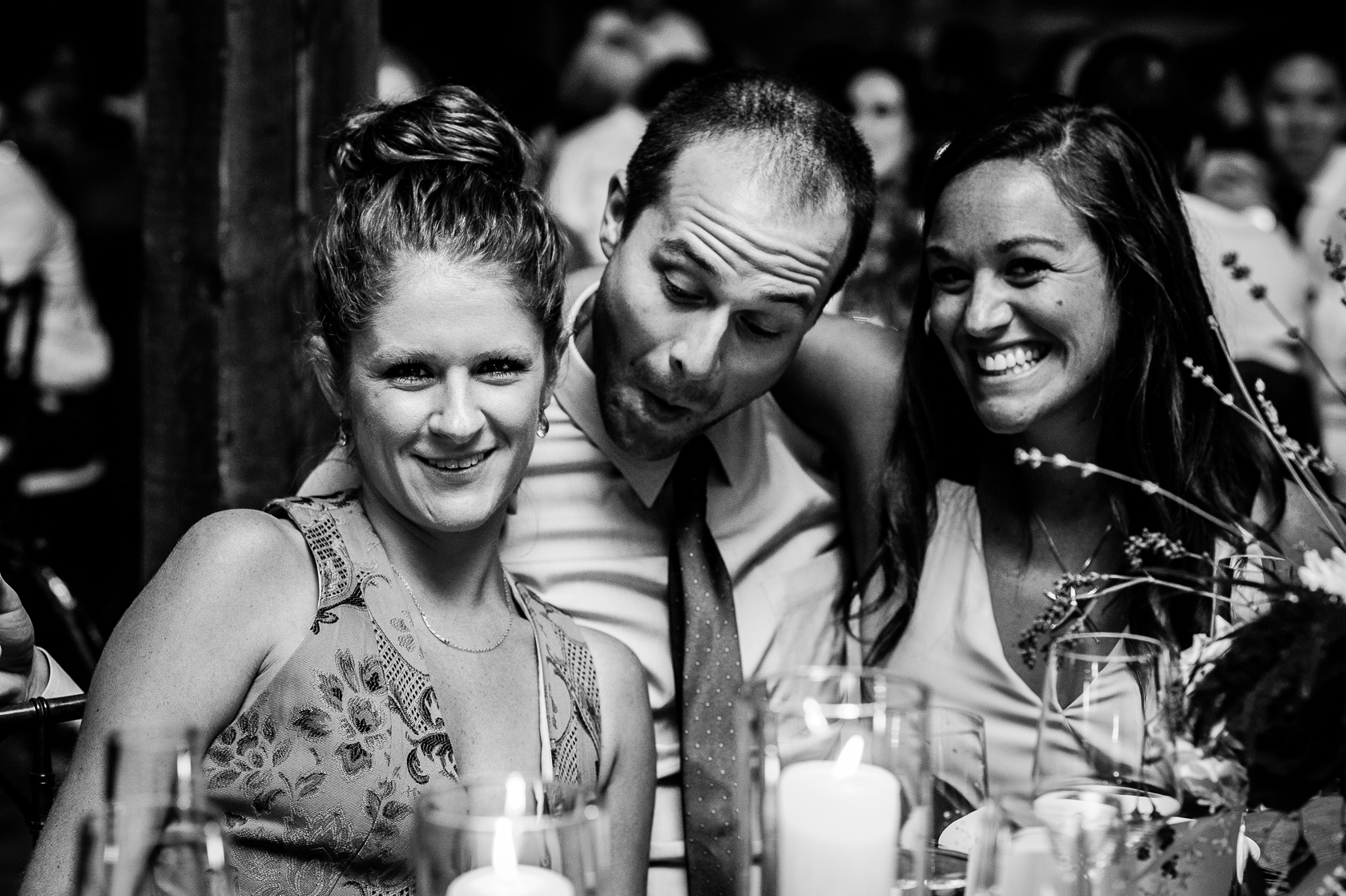 wedding guests goofing off during fall barn wedding 