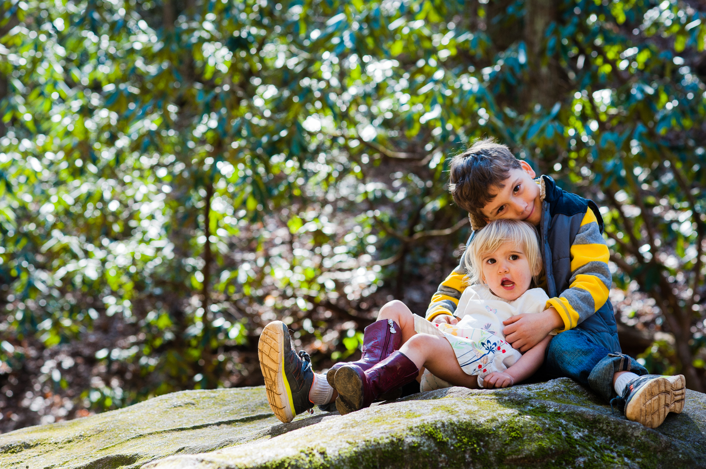 brother and sister pose for an adorable picture in the woods