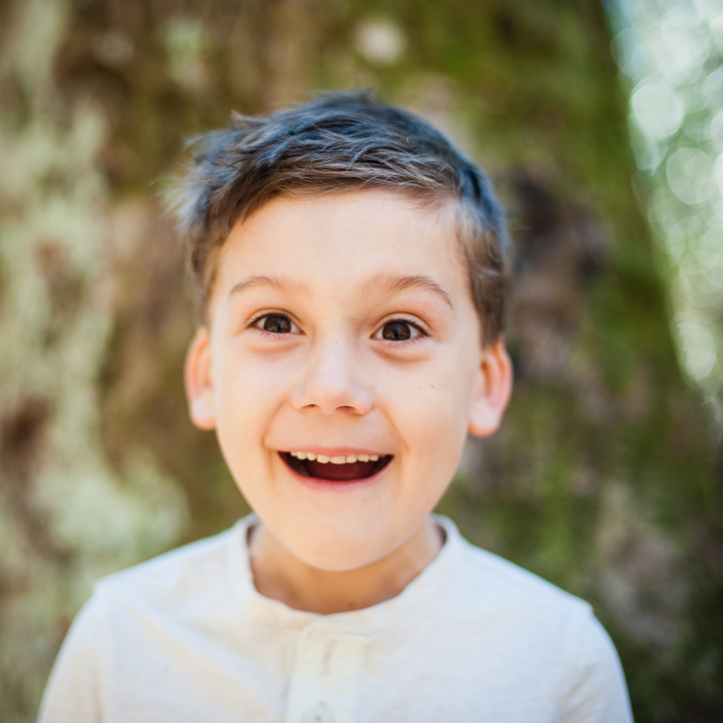 adorable boy goofs off during his outdoor photo session 