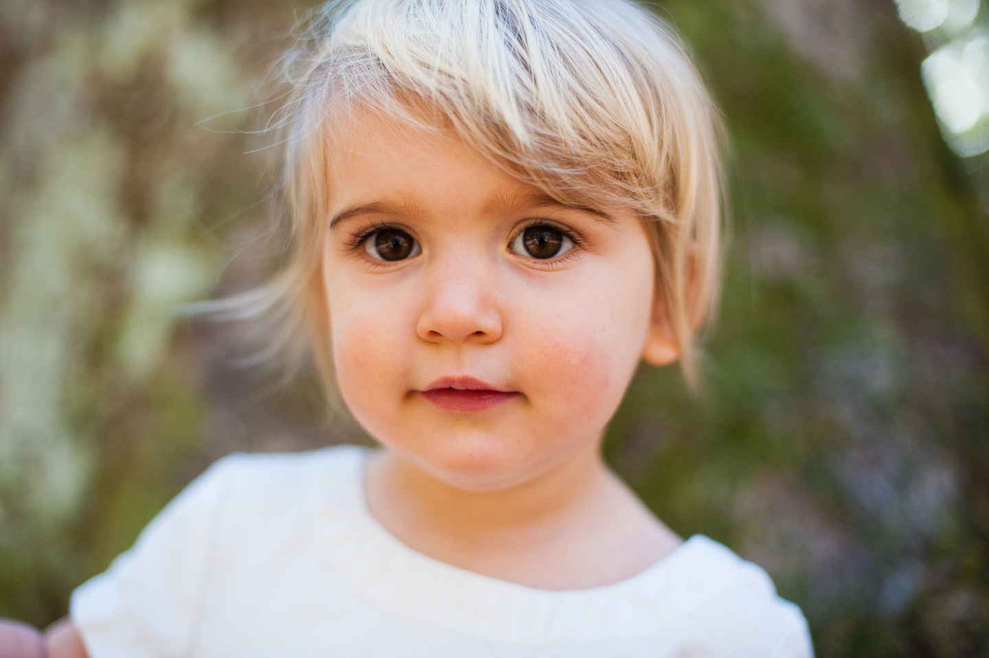 gorgeous little girl poses in woods during her lifestyle portrait session in boone nc