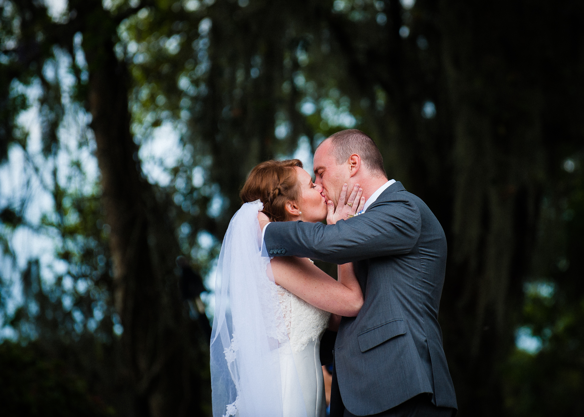 bride and groom first kiss during Magnolia Plantation wedding 