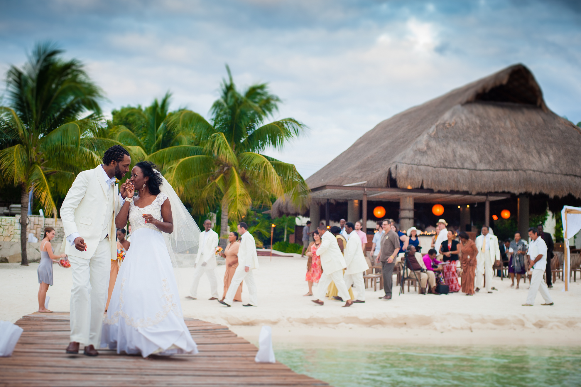 Couple walks down dock after Zama Beach Club ceremony