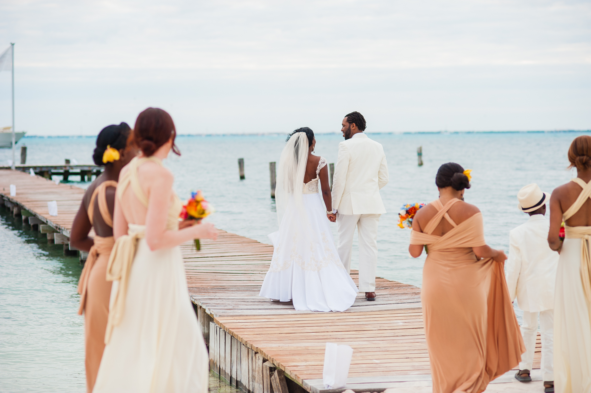 bride and groom walking down zama beach club dock 