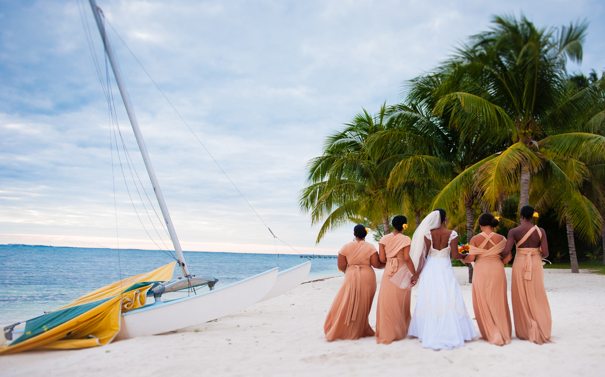 beautiful bridesmaids walking on beach on Isla Mujeres