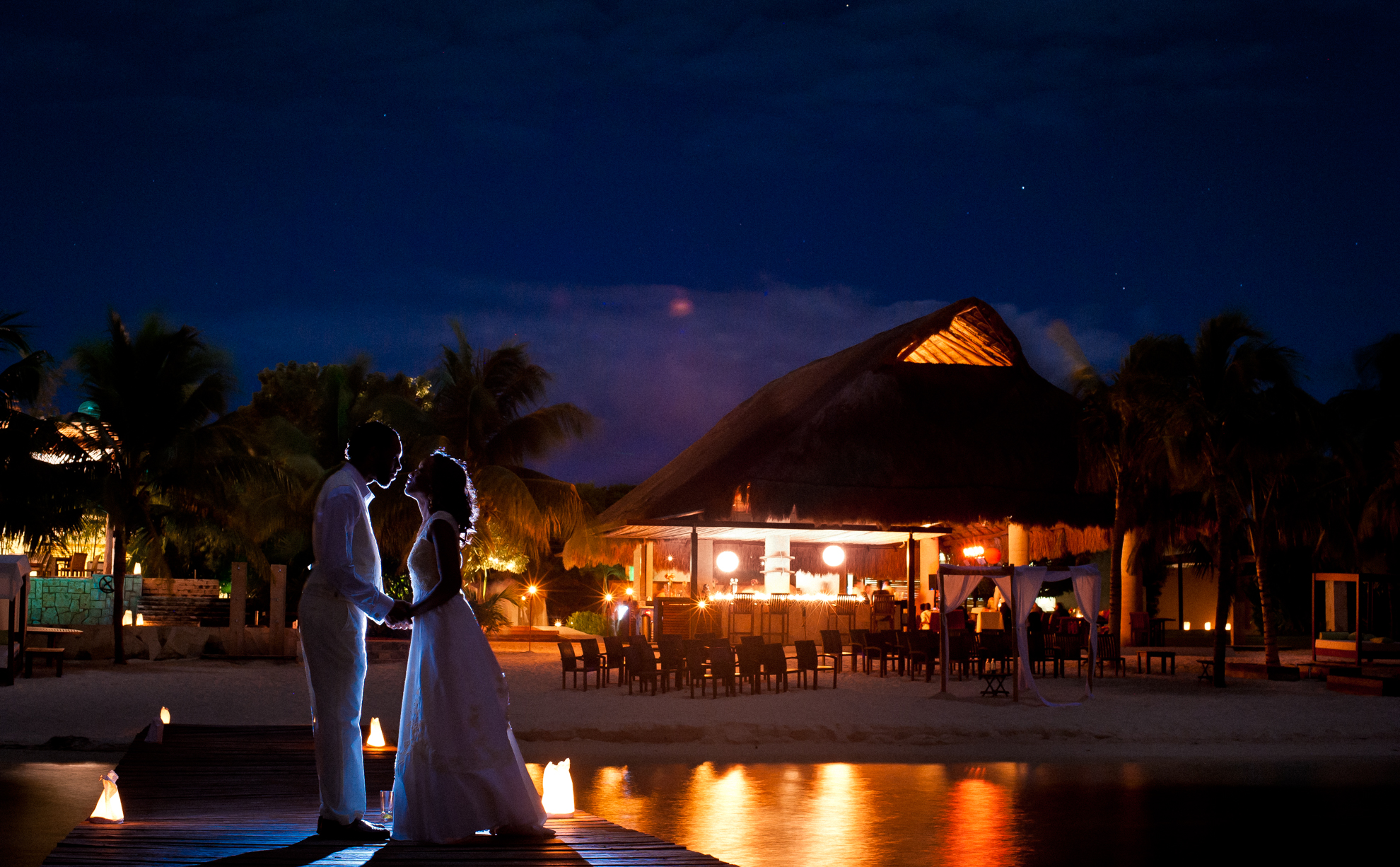 bride and groom at night on dock at zama beach club 