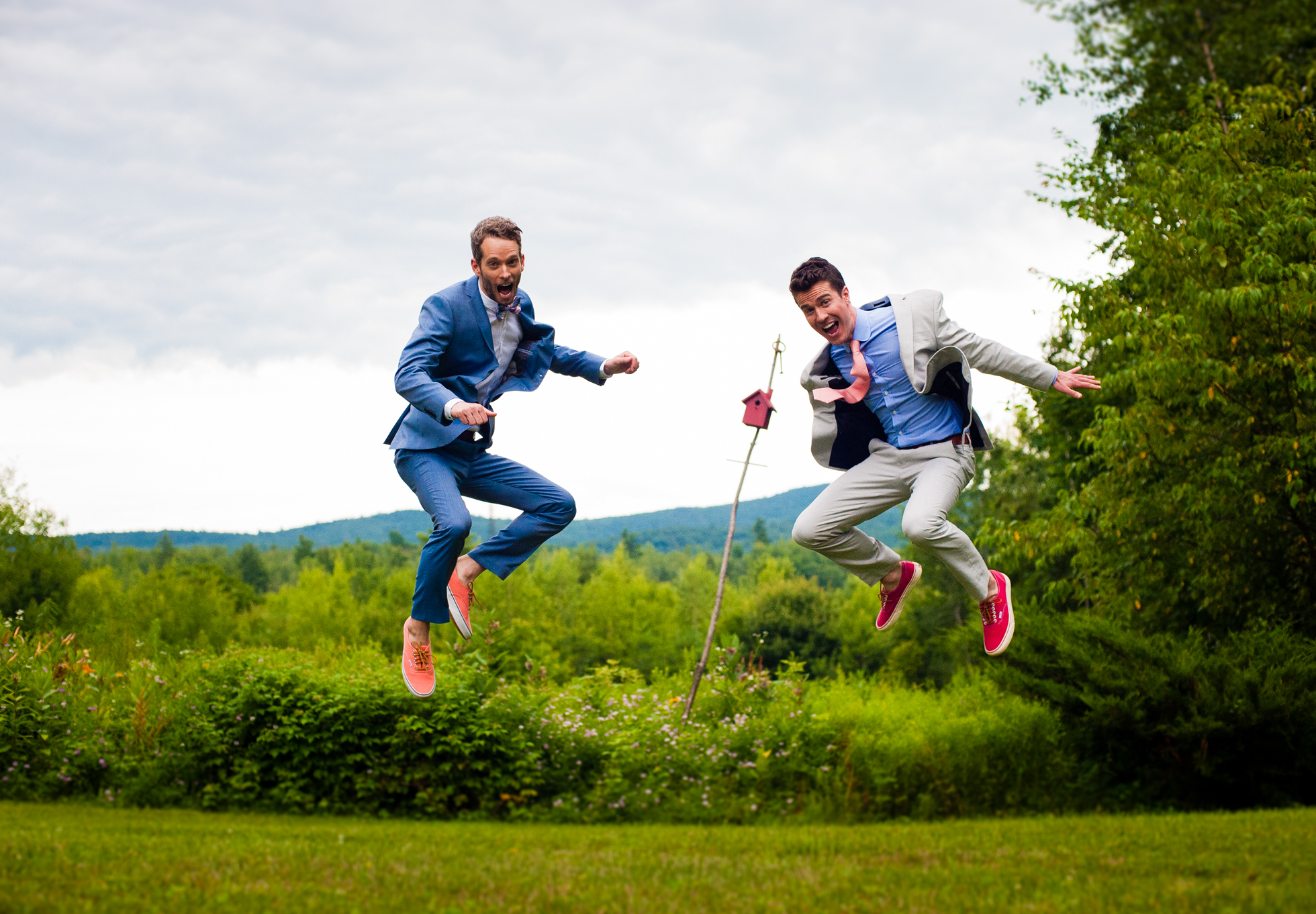two guys jump for joy at their backyard asheville wedding